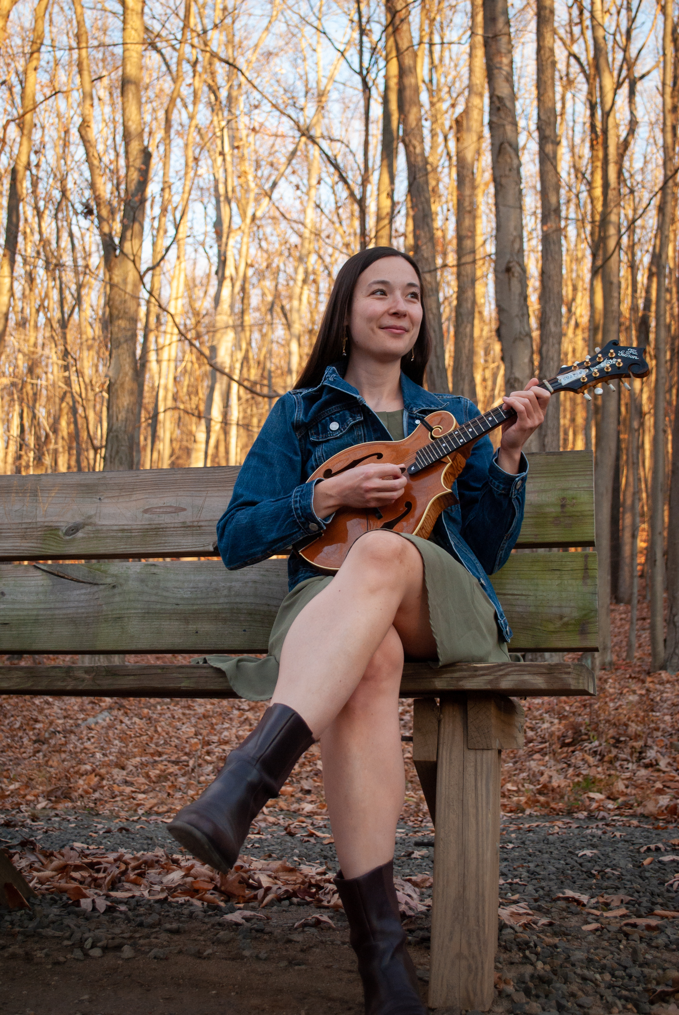 Cyrenah Smith playing mandolin outside.
